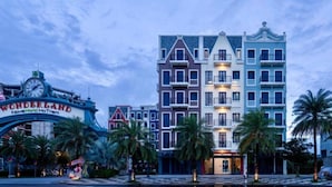 A multi-story hotel with a classic European architectural style, featuring balconies and a central entrance. - Maison Villa By The Sea (Ho Chi Minh City)