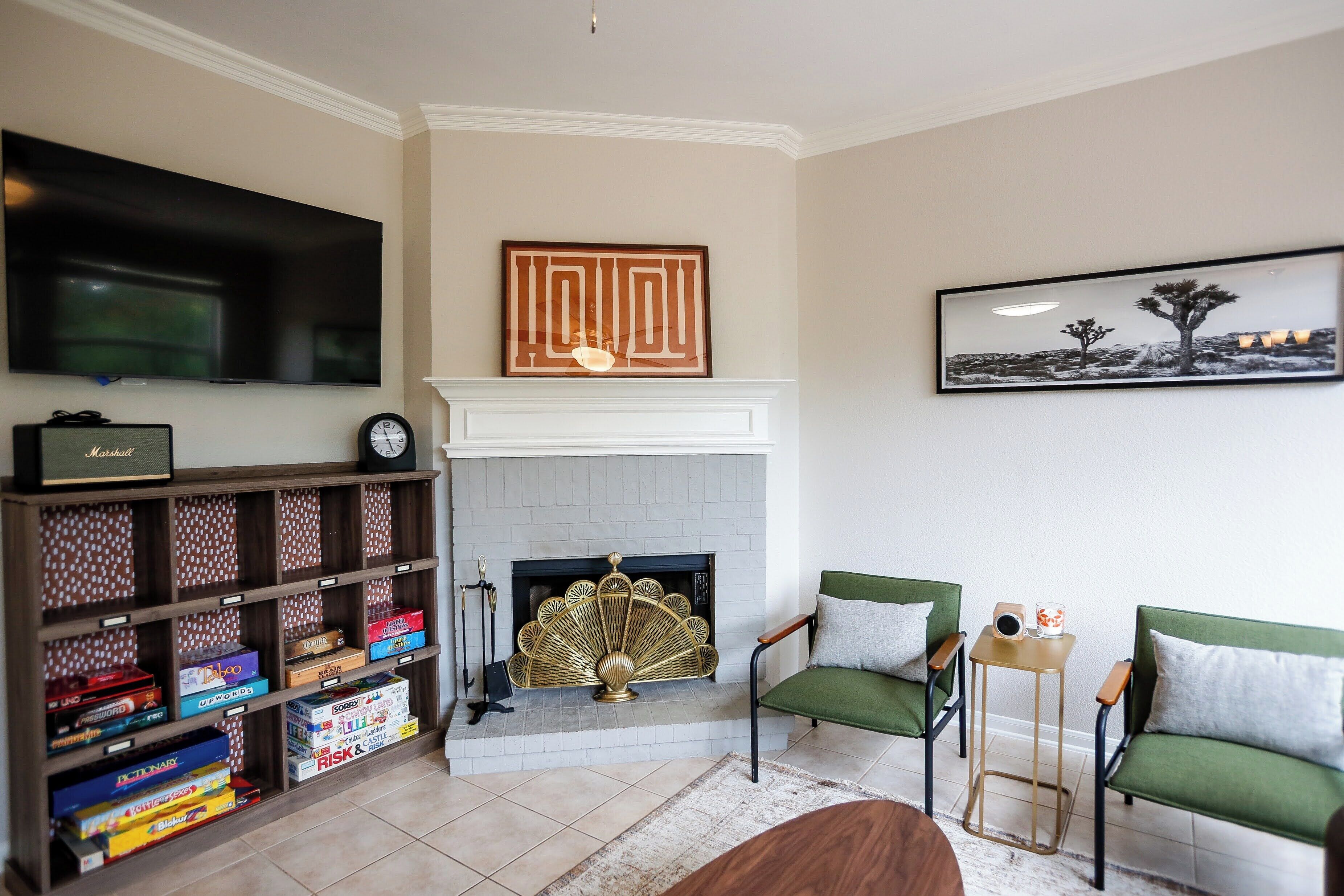 A living room with a fireplace, a television, and a bookshelf.