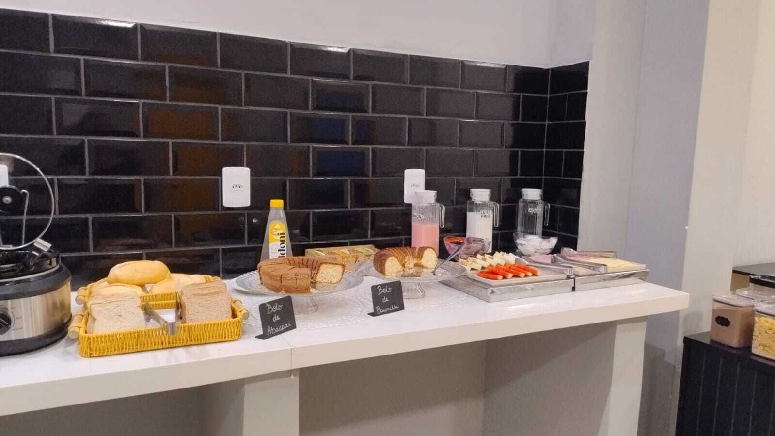A buffet counter with various food items and condiments.
