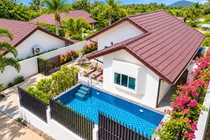 A residential property with a swimming pool, a fenced yard, and a red-roofed house. - Chalong Hideaway Pool Villa (Phuket)