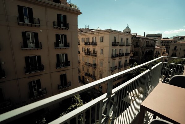 A balcony with a view of adjacent buildings, featuring multiple balconies and windows. - Borghi di Belmonte (Palermo)
