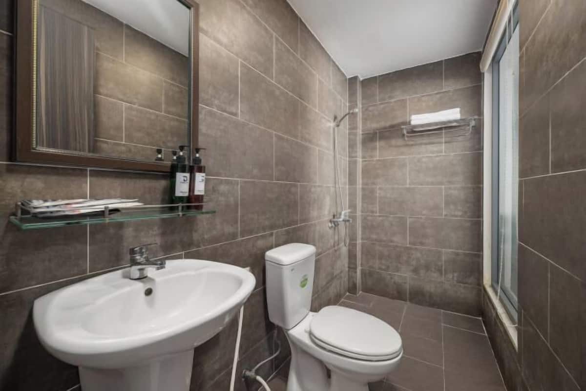 A bathroom with a sink, toilet, and shower.