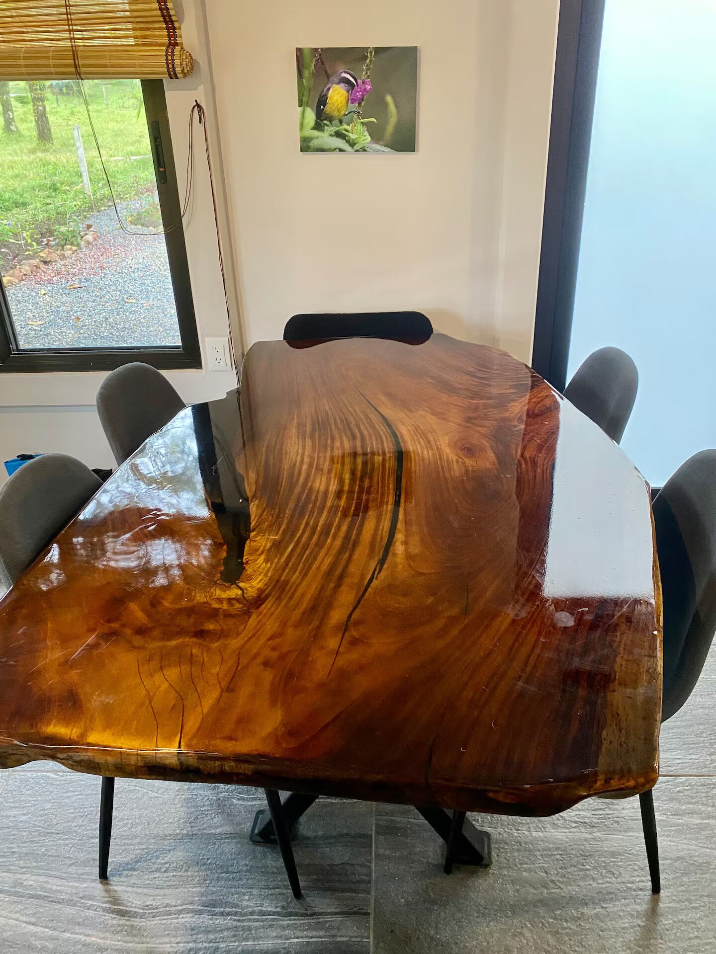 A conference table with a unique wood grain design, surrounded by chairs.
