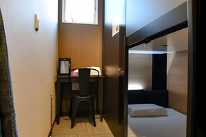 A compact room with a bunk bed, a desk with a chair, and a small window. - Male Only H2O Stay Ōtorii (Tokyo)