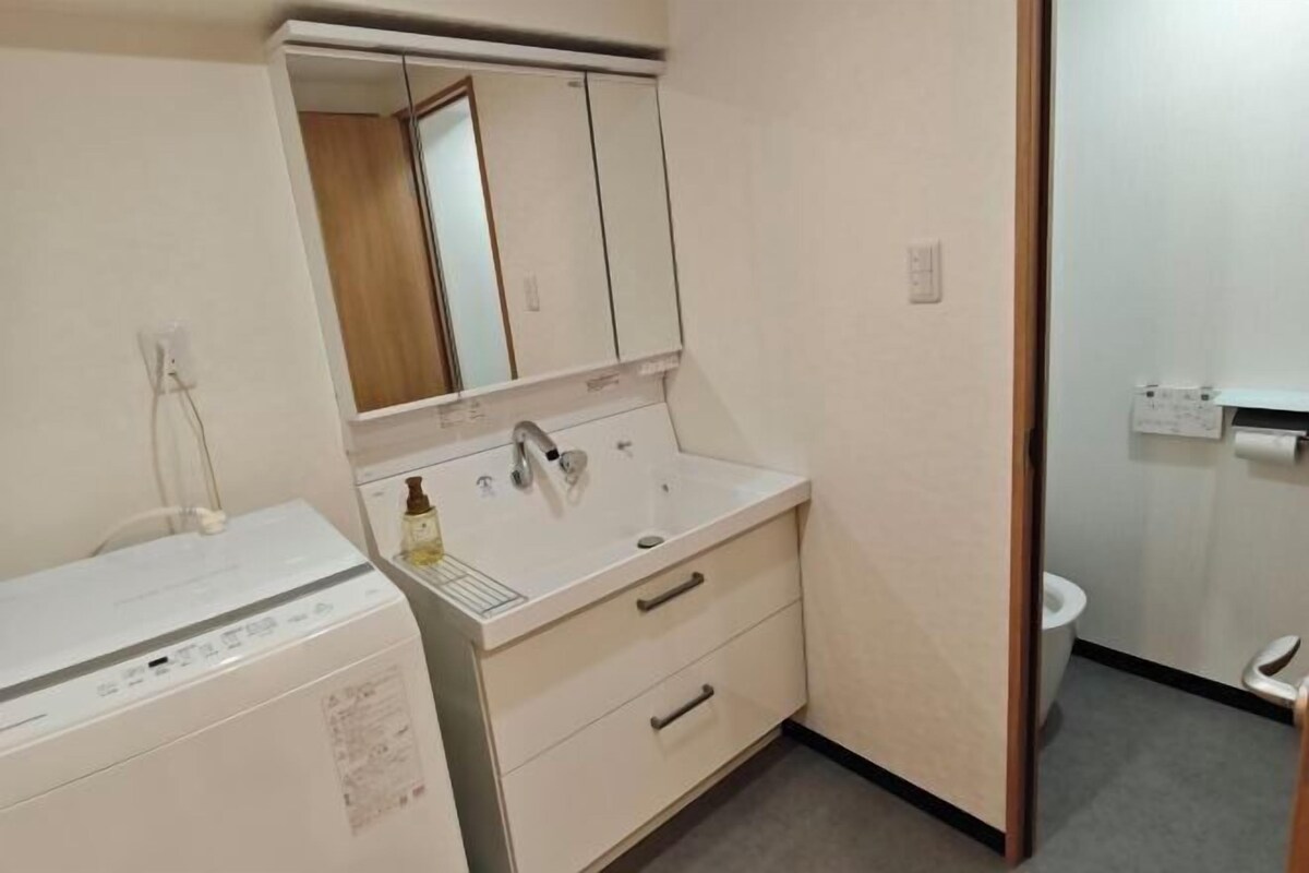 A small bathroom with a sink, mirror, and toilet.