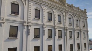 A classical building with arched windows and decorative moldings.
