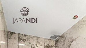 A modern bathroom with a marble wall, a wooden stool, and a shower area. - Studio JAPANDI in wonderful Miami with AC (Miami)