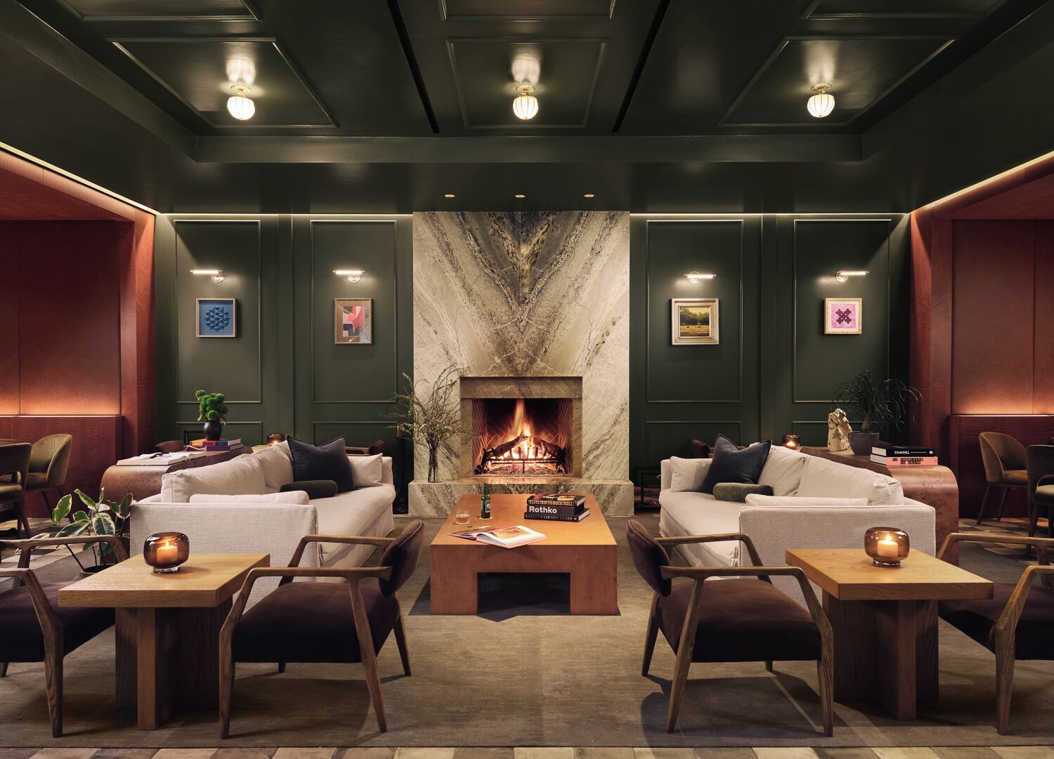 A cozy lounge area with a fireplace, comfortable seating, and a modern design.