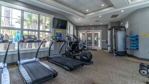 A gym with treadmills, elliptical machines, and weight equipment. - 4763 Solterra (Davenport)