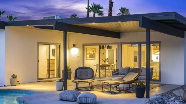 A modern outdoor living area with a pool, lounge chairs, and a covered patio. - Modern West PS - Welcome to Paradise! (Palm Springs)