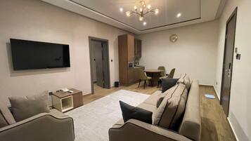 Luxury Suite | Living area | TV