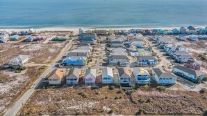 An aerial view of a coastal residential area with houses, a beach, and a clear sky. - 1 BLOCK to the BEACH! Weekly/Monthly promotions! Bay views! Dog friendly! (Gulf Shores)