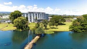 A large, modern hotel with multiple floors and a central courtyard. - Hilo Lagoon Center (Hilo)