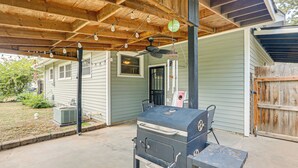 An outdoor patio with a grill, wooden ceiling, and string lights. - 2 Mi to Zoo, Fenced Yard: Family Home in Wichita! (Wichita)