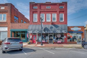 A Red Brick Deli with a brick facade, a red awning, and a storefront with various food items listed. - Explore Historic Dtwn! Walkable Loft in Murphy (Murphy)