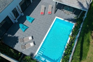 A rooftop pool area with lounge chairs and a swimming pool. - Villa Mokkaran, 3 Bedrooms (Koh Samui)