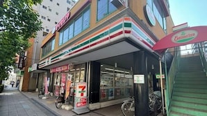 A 7-Eleven convenience store with a bicycle parked outside. - Hotel Arashi Nipponbashi East No.8111 (Osaka)