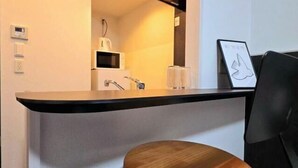 A modern bathroom with a sink, mirror, and a framed artwork on the wall. - Hotel Arashi Nipponbashi East No.8111 (Osaka)