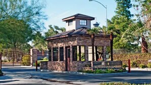 A small, stone building with a sign reading "Las Vegas Country Club Estates." - +Guard Gated Golf Course Front 1mi to Vegas Strip, Quiet Secure best kept secret (Las Vegas)