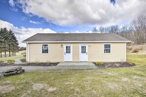 A single-story building with a gabled roof, a front door, and two windows on the side. - A Refined Retreat in the Pocono Mountains (Pleasant Mount)