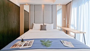 A modern hotel room with a large bed, a bedside table, a wardrobe, and a large window with curtains. - Exclusive And Modern 2Br Apartment Branz Bsd City (Pagedangan)