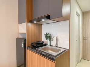 Standard Apartment | Private kitchen | Cookware/dishes/utensils - Wooden Space Studio At Meikarta Apartment (Cikarang)