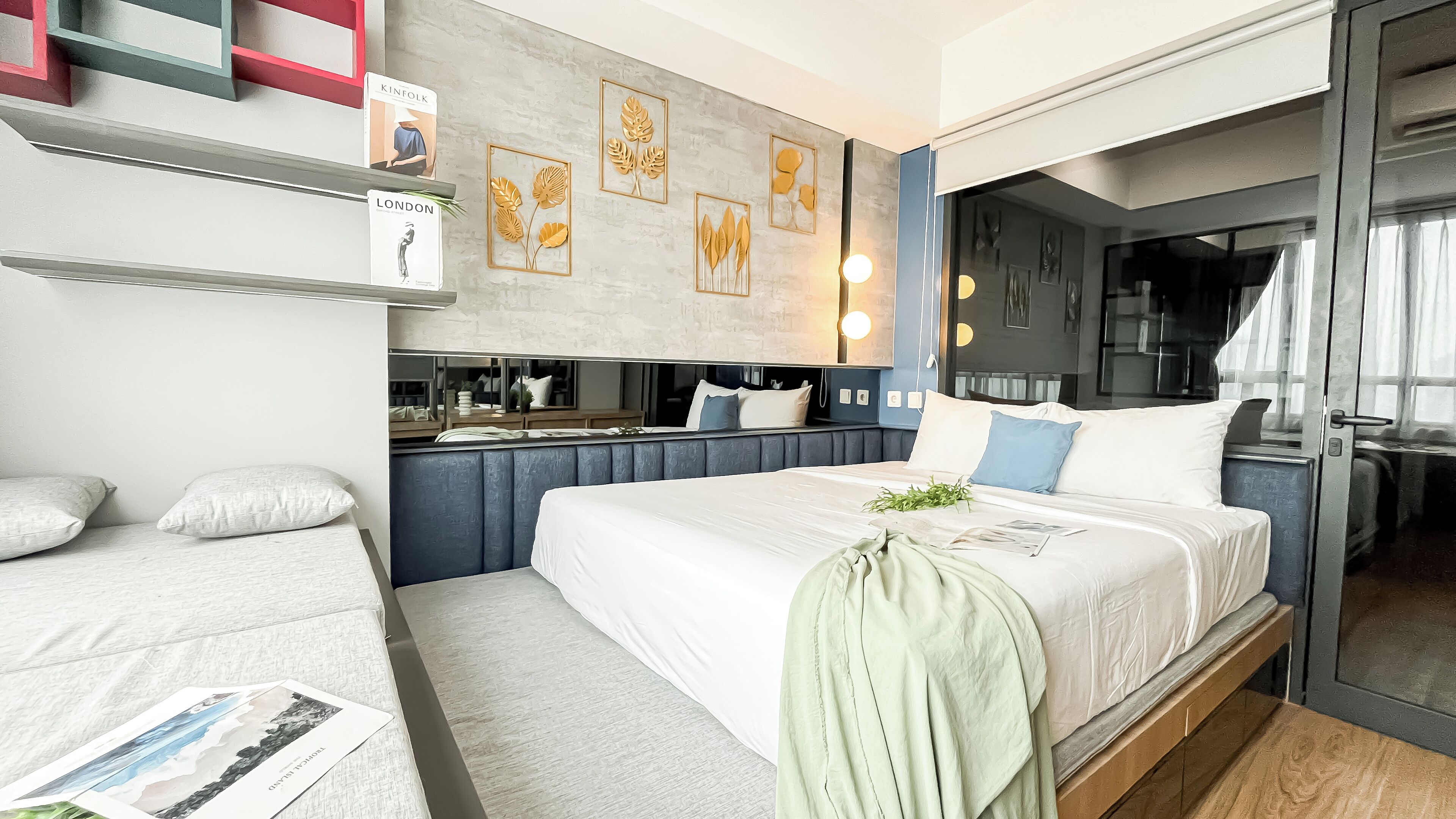 A modern bedroom with a large bed, bedside tables, and a built-in wardrobe.
