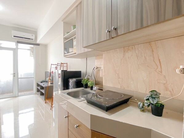 Apartment | Private kitchen | Fridge, stovetop, cookware/dishes/utensils - Modern Compact Studio Apartment At Vasanta Innopark (Cikarang)