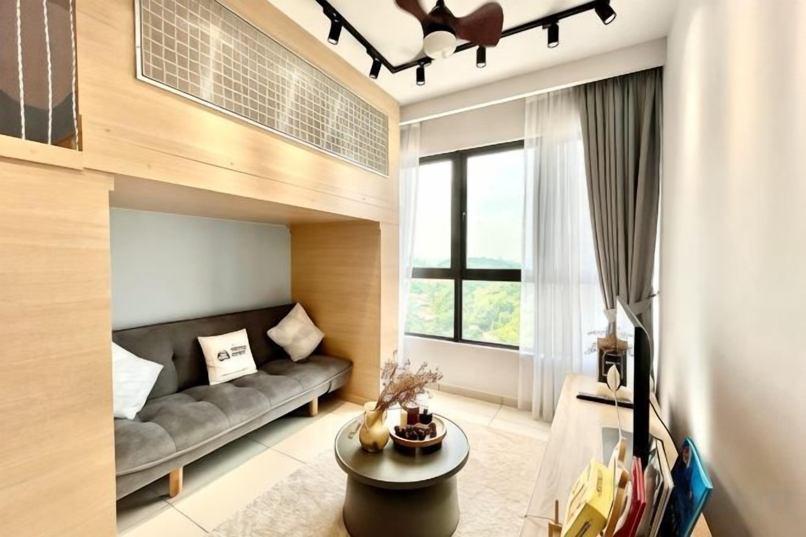 A modern living room with a sofa, a coffee table, and a large window with curtains.