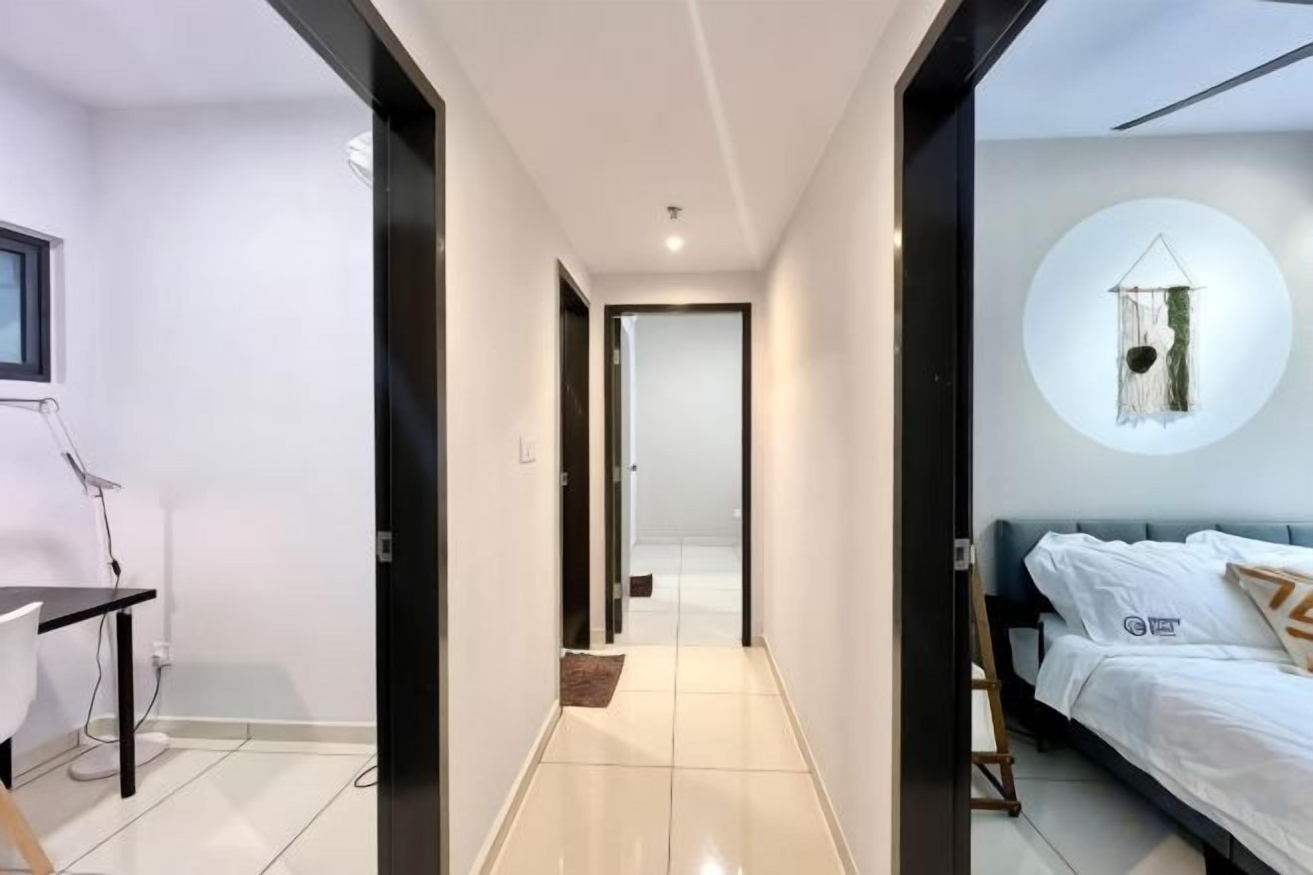 A modern bedroom with a bed, a desk, and a wall-mounted circular decor.