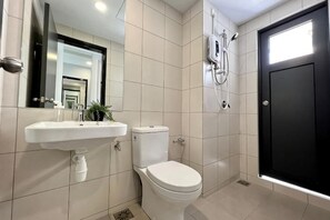 A bathroom with a sink, toilet, mirror, and shower. - Gaia Residence, Gamuda Gardens Rawang by Sleepy Bear (Rawang)