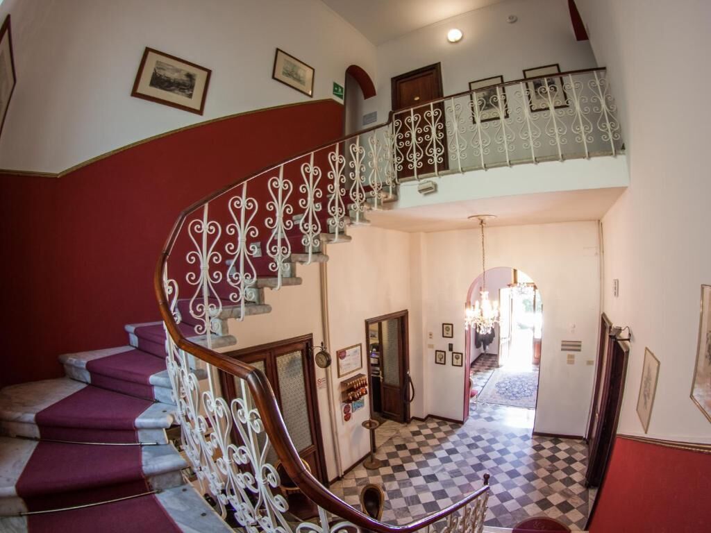 A staircase with ornate white railings and a checkered floor.