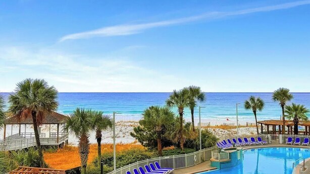 A pool area with lounge chairs, a gazebo, and a beach view. - 🦩Book Me Baby! Beach Penthouse at Pelican Beach🦩 (Destin)