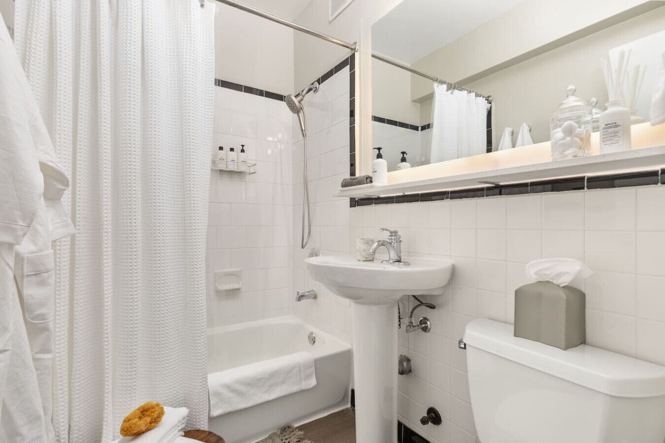A modern bathroom with a bathtub, a sink, and a toilet.