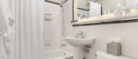 A modern bathroom with a bathtub, a sink, and a toilet.