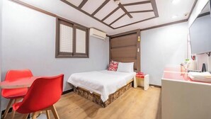 A bedroom with a bed, a desk, a chair, and a window. - Ritz Sillim (Seoul)