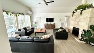 Smart TV, lareira, livros, aparelho de som