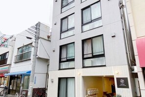 Un edificio moderno de varios pisos, con grandes ventanales y una entrada destacada.