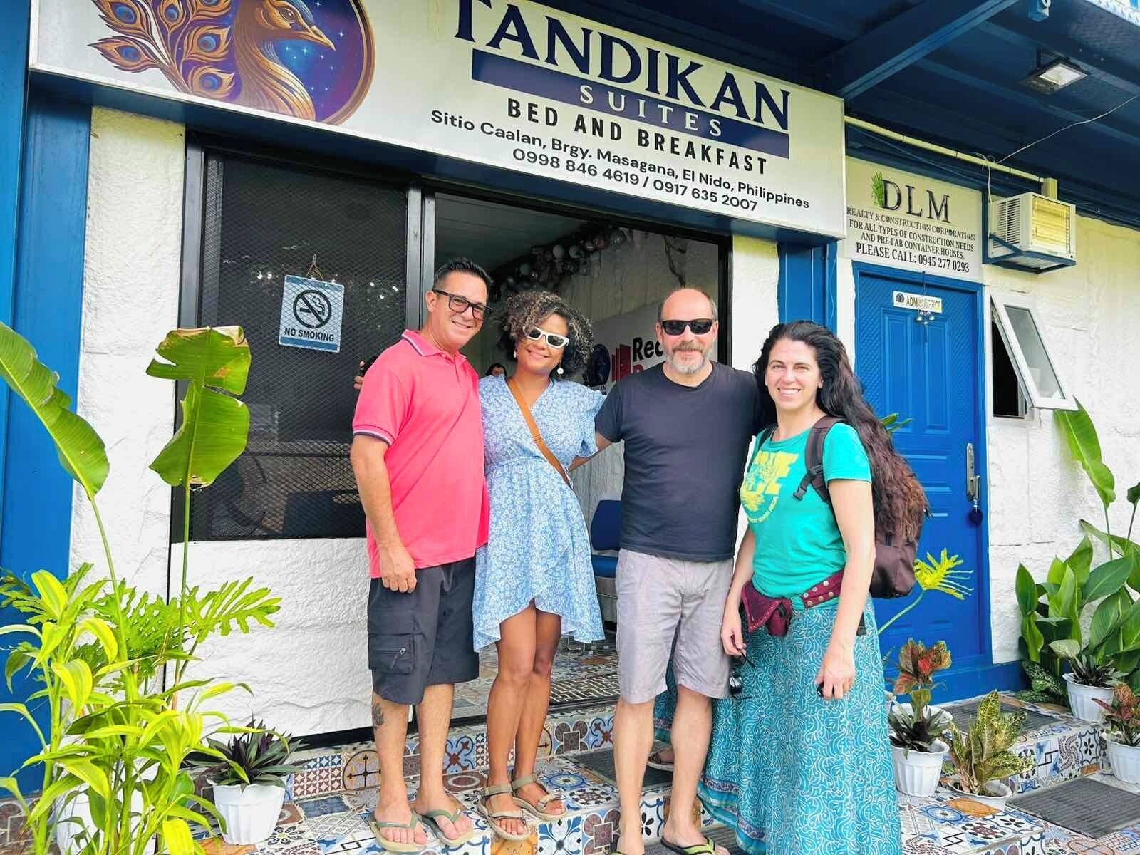 A building with a sign for 'FANDIKAN BED SUITES' and 'BED AND BREAKFAST'.