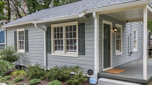 A residential house with a front porch, a mailbox, and a 'No Soliciting' sign. - Heart of Midtown - Newly Renovated - Atlanta Home (Atlanta)