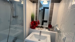 A modern bathroom with a glass-enclosed shower, a pedestal sink, and a mirror above the sink. - French Riviera getaway -Studio at Château des Artistes (Le Cannet)