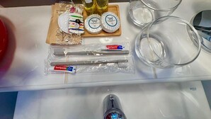 A bathroom sink area with toiletries including toothbrushes, toothpaste, soap, and shampoo bottles. - French Riviera getaway -Studio at Château des Artistes (Le Cannet)