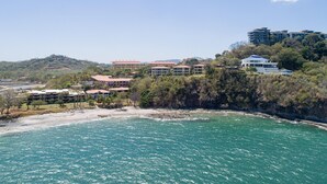 A coastal area with buildings, a beach, and a clear sky. - Flamingo Center: 2 BR condo w| gorgeous bay views - Punta Plata 521 (Playa Flamingo)