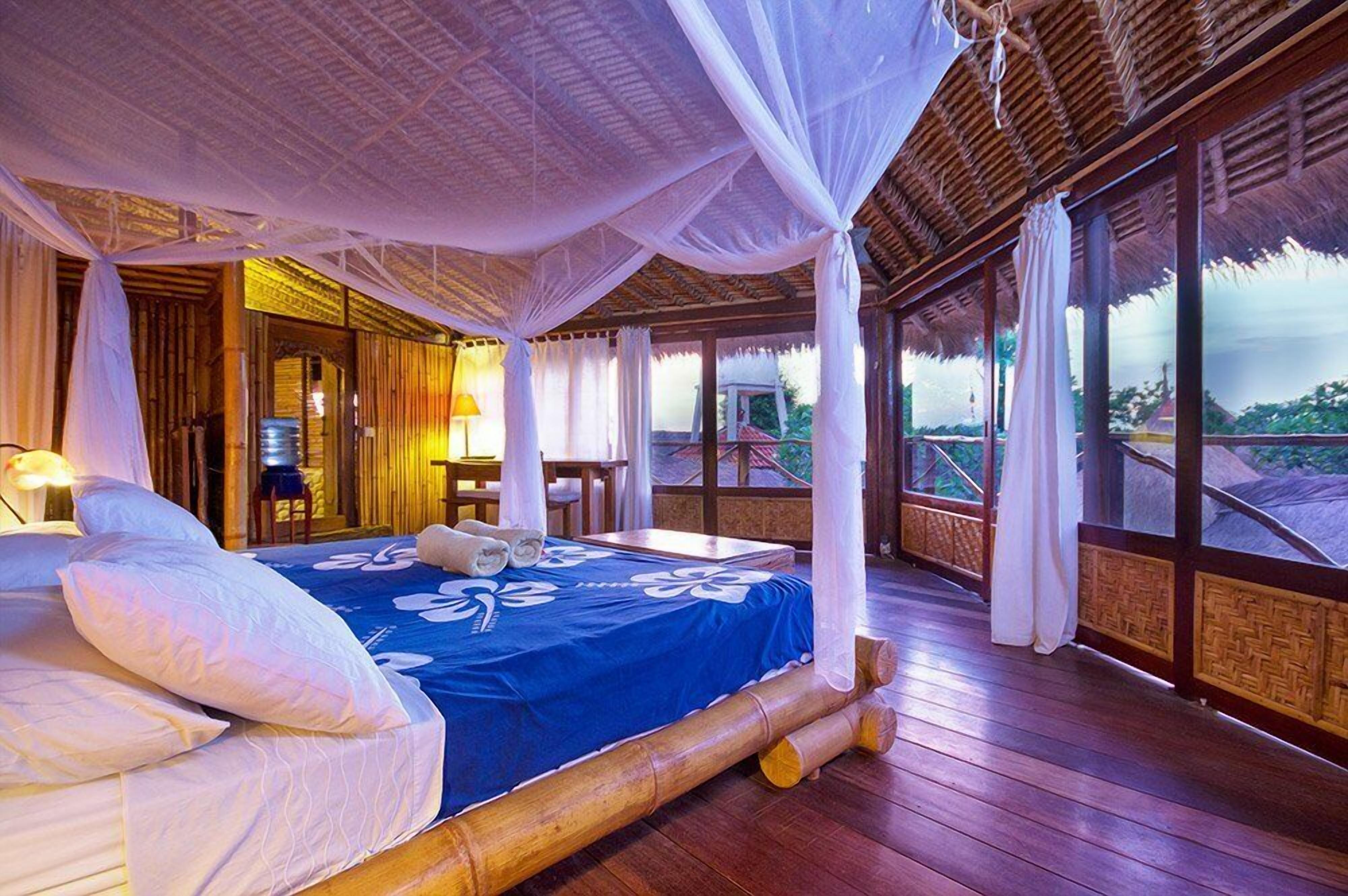 Una habitación con cama, una mesa y una silla.