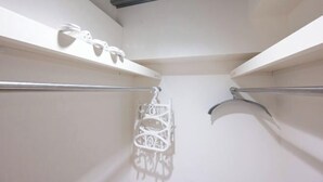 A bathroom with white walls, a metal ceiling, and a white towel rack. - Gran FusionIkebukuro (Tokyo)