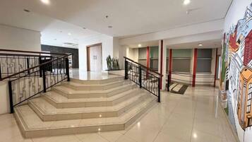 A staircase with metal railings leading to a landing.