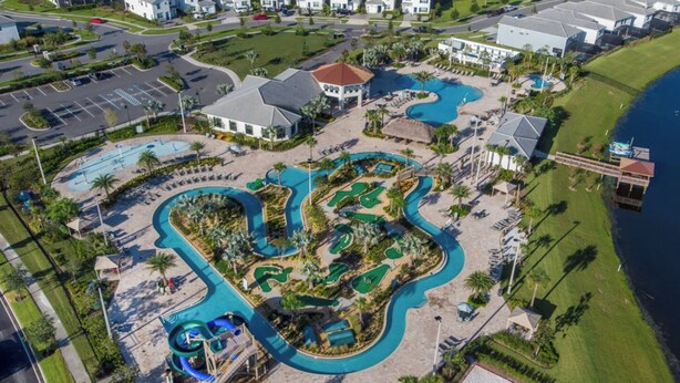An aerial view of a resort with multiple swimming pools, a golf course, and beachfront properties. - 6BR Disney Retreat w/ Pool, Game Loft & Resort Amenities (Kissimmee)
