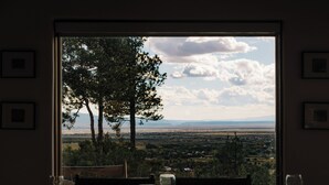 A dining table with plates, glasses, and a view of a landscape with trees and mountains. - Salto Retreat, Valley Views, HotTub, Patio, Hiking (Arroyo Seco)