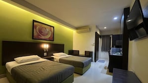 A hotel room with two beds, a TV, a painting, and a desk with a lamp. - Suansin Lanna Hotel (Tak)