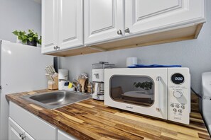 Fridge, microwave, stovetop, coffee/tea maker